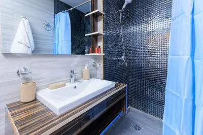 a bathroom with a sink and a shower at Chic & Spacious : 3BR Apartment in Central Rabat in Rabat