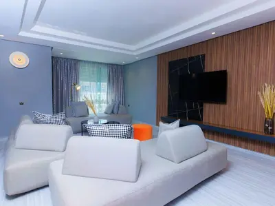 a living room with a white couch and a tv at Chic & Spacious : 3BR Apartment in Central Rabat in Rabat
