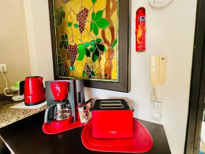 a counter with a red toaster and a coffee maker at Rabat Agdal Pearl - 2BR Spacious & Well located in Rabat