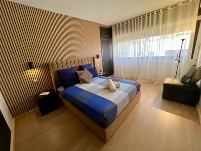 a bedroom with a large bed and a window at Rabat Agdal Pearl - 2BR Spacious & Well located in Rabat