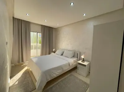 a bedroom with a white bed and a window at F4 Appartement entièrement neuf au cœur de Témara in Temara