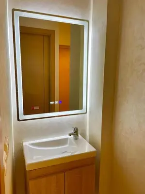 a bathroom with a white sink and a mirror at F4 Appartement entièrement neuf au cœur de Témara in Temara