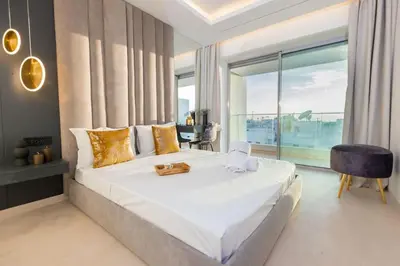a bedroom with a large bed and a large window at Aristocratic Abode: Luxurious 2BR Flat in Agdal in Rabat