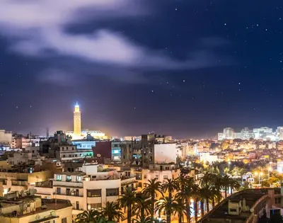 a city skyline at night with a clock tower at Luxurious apartment, European Quality in Casablanca