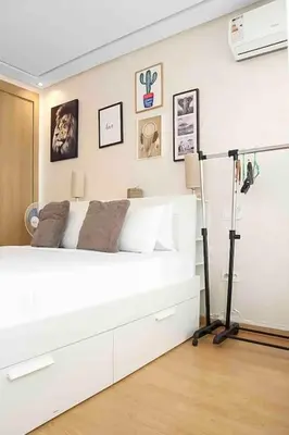 a bedroom with a large white bed and a tripod at BeachSide marvel in Casablanca