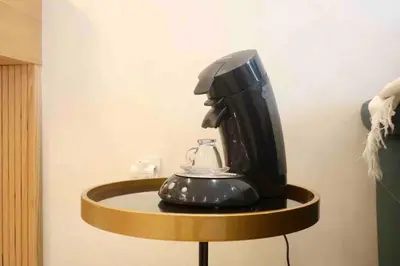 a black coffee maker on a shelf in a room at BeachSide marvel in Casablanca