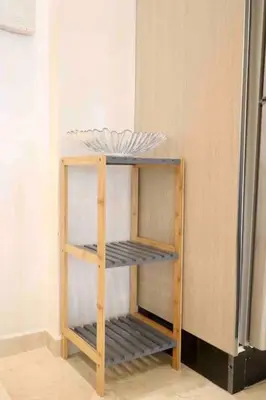 a wooden shelf in a kitchen next to a refrigerator at BeachSide marvel in Casablanca