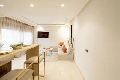 a kitchen and living room with a couch and a table at #3 New Upscale flat in new building in Casablanca