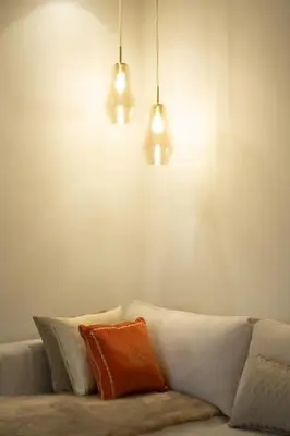 a couch with three pillows and two lights above it at #3 New Upscale flat in new building in Casablanca