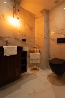 a bathroom with a black toilet and a sink at #3 New Upscale flat in new building in Casablanca