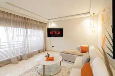 a living room with a couch and a tv on the wall at #3 New Upscale flat in new building in Casablanca