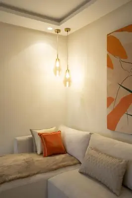 a living room with a couch with an orange pillow at #3 New Upscale flat in new building in Casablanca