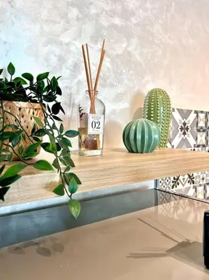 a wooden shelf with plants and a sign on it at Appartametno moderno centro di casa in Casablanca