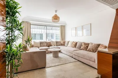 a living room with a couch and a table at 2 Bedrooms Casablanca City Center in Casablanca