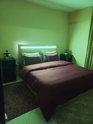 a bedroom with a large bed with purple sheets and pillows at Appartement chic, moderne vue sur mer in Casablanca
