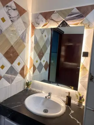 a bathroom with a sink and a mirror at Appartement chic, moderne vue sur mer in Casablanca