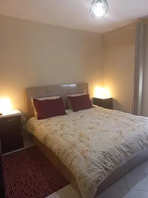 a bedroom with a bed with two pillows on it at Appartement chic, moderne vue sur mer in Casablanca