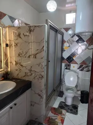 a bathroom with a shower and a toilet and a sink at Appartement chic, moderne vue sur mer in Casablanca