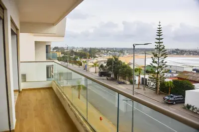 a balcony of a building with a view of a street at Luxurious Apt - Sea View in Pont Blondin
