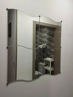 a mirror in a bathroom with a sink at Mohammedia Relax in Mohammedia