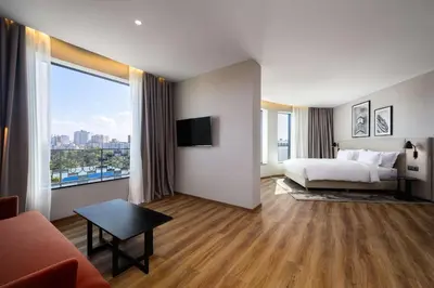 a hotel room with a bed and a large window at Radisson Hotel Casablanca Gauthier La Citadelle in Casablanca
