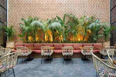 a long table with chairs and plants on a wall at Radisson Hotel Casablanca Gauthier La Citadelle in Casablanca
