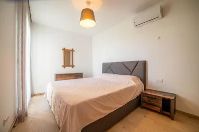 a bedroom with a large bed in a white room at Magnifique oasis de détente ! in Bouznika