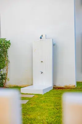 a white refrigerator sitting next to a white wall at Magnifique oasis de détente ! in Bouznika