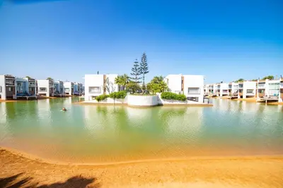 a large body of water in front of buildings at Magnifique oasis de détente ! in Bouznika