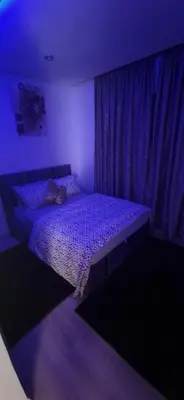 a bedroom with a bed in a purple room at Zenata ocean park appartement in Mohammedia