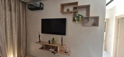 a living room with a flat screen tv on a wall at Zenata ocean park appartement in Mohammedia