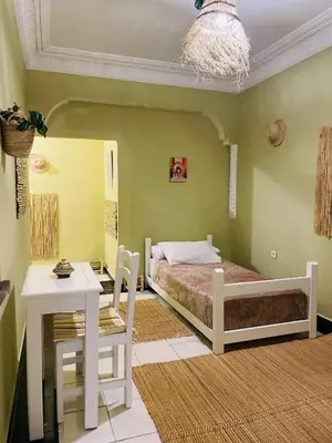 a bedroom with a bed and a table in a room at Beautiful Studio In Casablanca in Casablanca