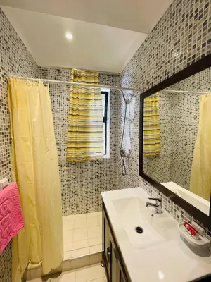 a bathroom with a sink and a shower and a mirror at Beautiful Studio In Casablanca in Casablanca
