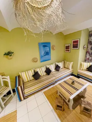 a living room with a couch and a table at Beautiful Studio In Casablanca in Casablanca
