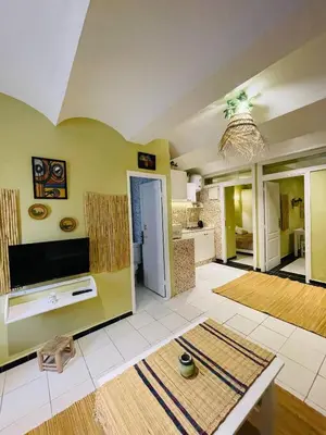 a large living room with yellow walls and a kitchen at Beautiful Studio In Casablanca in Casablanca