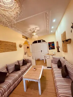 a living room with two couches and a table at Magnificent studio for two in the center of Casablanca in Casablanca