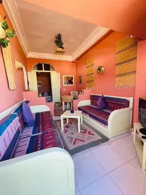 a living room with pink and purple walls at Pleasant Studio In Casablanca in Casablanca