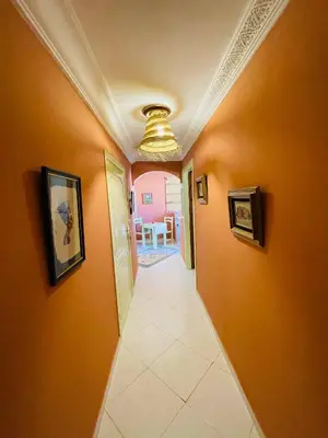 a hallway with orange walls and a ceiling at Pleasant Studio In Casablanca in Casablanca