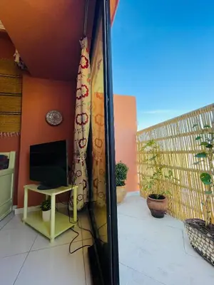 a view of a balcony with a television and a table at Pleasant Studio In Casablanca in Casablanca