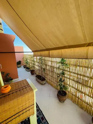 a balcony with potted plants and a wooden fence at Pleasant Studio In Casablanca in Casablanca