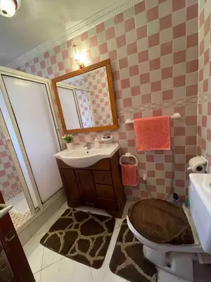 a bathroom with a sink and a toilet and a mirror at Pleasant Studio In Casablanca in Casablanca
