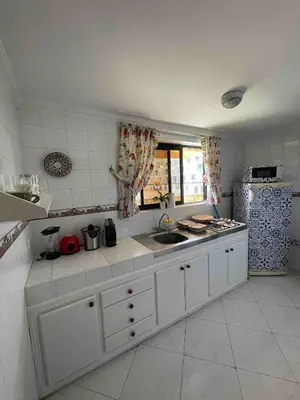 a white kitchen with a sink and a refrigerator at Pleasant Studio In Casablanca in Casablanca