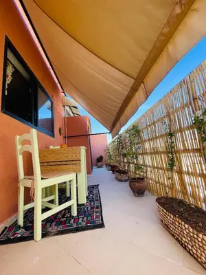 a wooden bench on a balcony with plants at Pleasant Studio In Casablanca in Casablanca