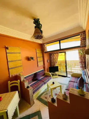 a living room with a couch and a table at Pleasant Studio In Casablanca in Casablanca