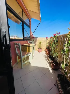a patio with a table and chairs and potted plants at Beautiful Studio in the heart of Casablanca in Casablanca