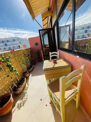 a balcony with a chair and a table and window at Beautiful Studio in the heart of Casablanca in Casablanca