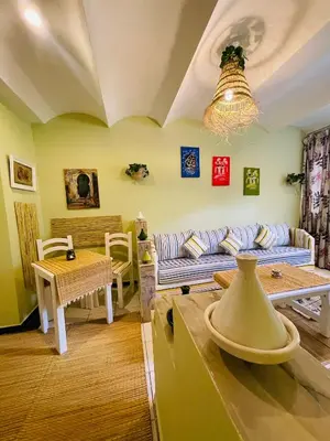 a living room with a couch and a table at Charming Getaway in Casablanca Maroc, Cozy Home with Thoughtful Amenities in Casablanca