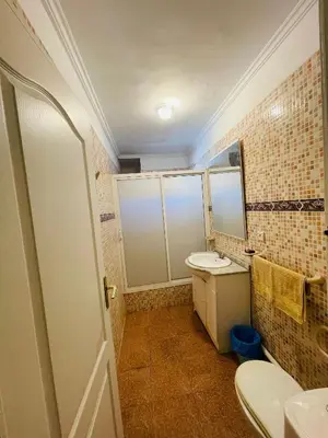 a bathroom with a toilet and a sink and a mirror at Charming Getaway in Casablanca Maroc, Cozy Home with Thoughtful Amenities in Casablanca