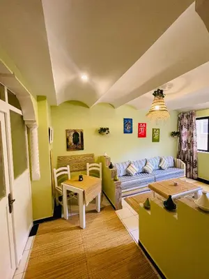 a living room with a couch and a table at Charming Getaway in Casablanca Maroc, Cozy Home with Thoughtful Amenities in Casablanca