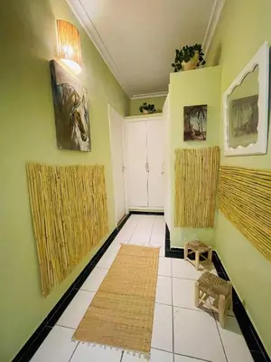 a living room with green walls and white tile floors at Charming Getaway in Casablanca Maroc, Cozy Home with Thoughtful Amenities in Casablanca